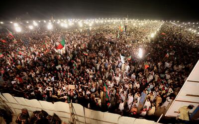 Supporters of opposition party Pakistan Tehrik-e-Insaf listen to former Prime Minister and head of the opposition political party Pakistan Tehrik-e-Insaf Imran Khan. EPA