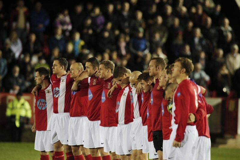 British Army players hold a minute silence prior to their football match against the German Army on Wednesday to commemorate the World War I Christas Day Truce. Lefteris Pitarakis / AP