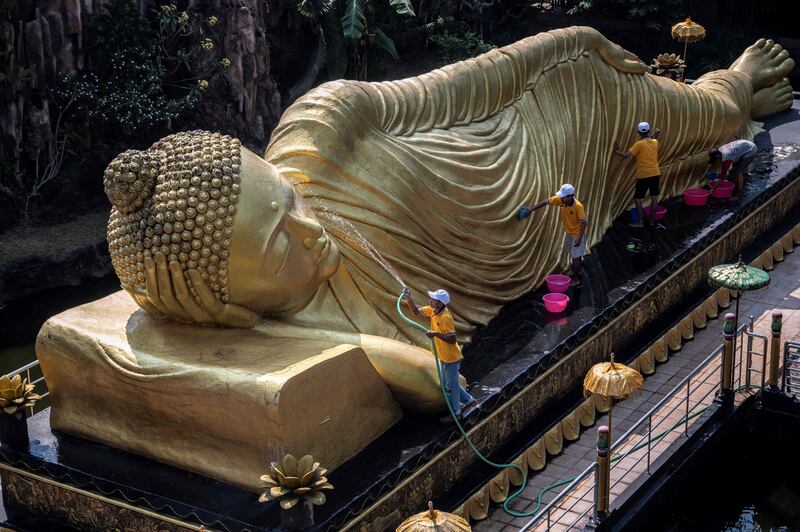 Workers clean a statue at Maha Vihara Mojopahit temple in Mojokerto, East Java, Indonesia ahead of the Vesak festival which commemorates the birth, enlightenment and death of Buddha. AFP