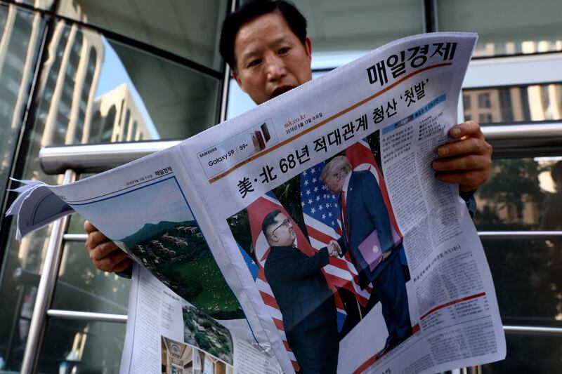 SEOUL, SOUTH KOREA - JUNE 12:  A South Korean man reads a newspaper reporting the U.S. President Trump meeting with North Korean leader Kim Jong-un on June 12, 2018 in Seoul, South Korea. U.S. President Trump and North Korean leader Kim Jong-un held the historic meeting between leaders of both countries on Tuesday morning in Singapore, carrying hopes to end decades of hostility and the threat of North Korea's nuclear programme.  (Photo by Chung Sung-Jun/Getty Images)