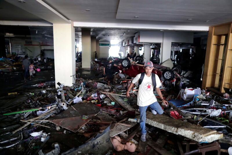 An Indonesian man walks inside a wrecked shopping mall in Talise beach, Palu, Central Sulawesi, Indonesia.  EPA