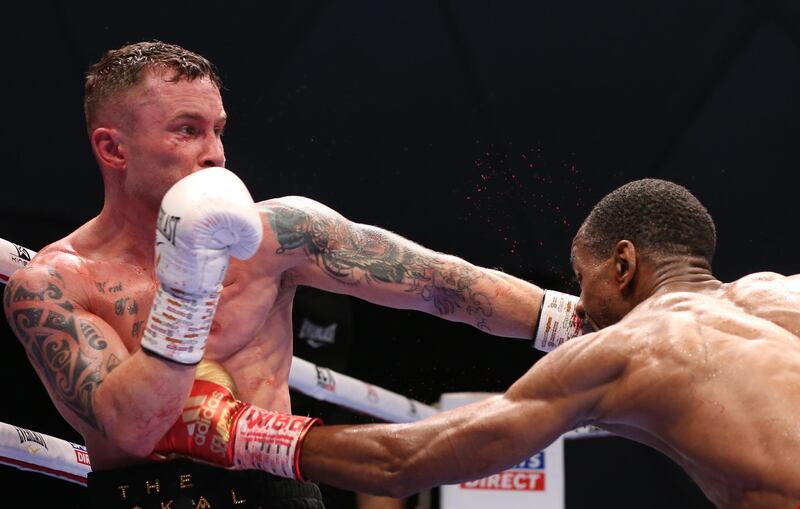 Carl Frampton defends against Jamel Herring.