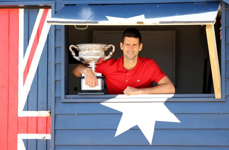 Australian Open champion Novak Djokovic poses with the trophy after his win last year. Reuter