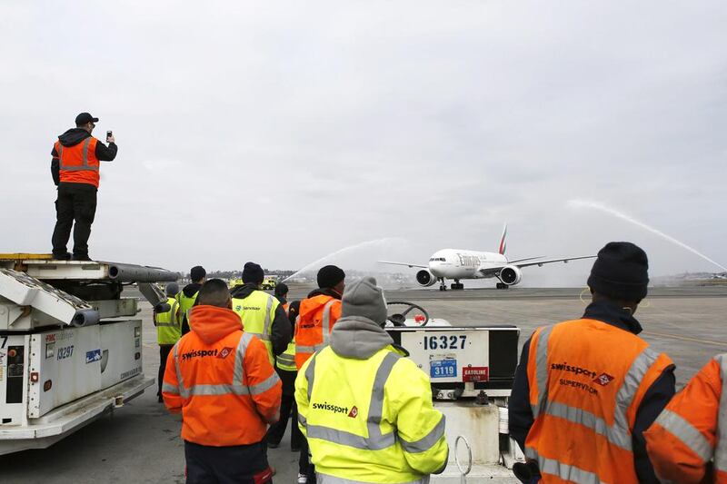 Workers watch Flight EK237 of Emirates Airline get a water salute during the Dubai carrier’s inaugural non-stop flight to Boston. AP Photo / The Boston Globe Jessica Rinaldi