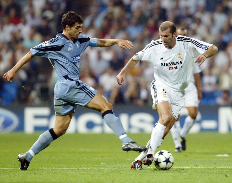MADRID, SPAIN - SEPTEMBER 16:  Zinedine Zidane of Real Madrid is challenged by Fabio Celestini of Marseille during the UEFA Champions League Group F match between Real Madrid and Olympic Marseille at the Santiago Bernabeu Stadium on September 16, 2003 in Madrid, Spain. (Photo by Shaun Botterill/Getty Images)