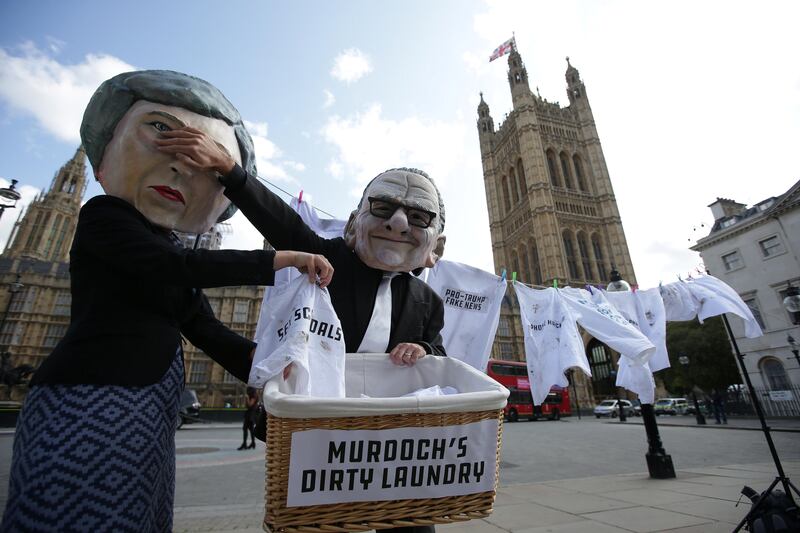 Activists from the community-based organization Avaaz satirically posing as Britain's Prime Minister Theresa May (L) and media mogul Rupert Murdoch (R), perform a stunt to protest against the proposed takeover of pan-European satellite TV giant Sky by Rupert Murdoch's 21st Century Fox entertainment group outside the Houses of Parliament in central London on September 12, 2017 where Britain's Culture, Media and Sport Secretary Karen Bradley updated lawmakers on her investigations into the proposed takeover.
Britain's Culture, Media and Sport Secretary Karen Bradley announced in the House of Commons that she is 'minded' to refer Murdoch's £11.7 billion bid for Sky to investigation by the Competitions and Markets Authority (CMA).  / AFP PHOTO / Daniel LEAL-OLIVAS