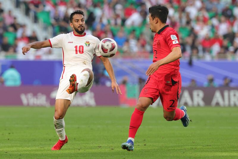 South Korea's Lee Ki-je fights for the ball with Jordan's Musa Al Tamari. AFP