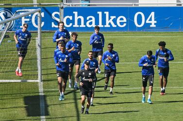 The team of German Bundesliga soccer club FC Schalke 04 exercises during a training session in Gelsenkirchen, Germany, Thursday, April 23, 2020. The German Bundesliga is expected to start playing the rest of the season in early May behind closed doors due to the coronavirus outbreak. (AP Photo/Martin Meissner)