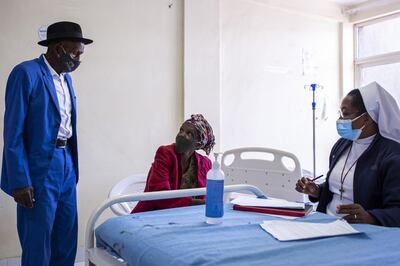 A nurse registers the details of an elderly resident for the Covishield Covid-19 vaccine, developed by AstraZeneca Plc and the University of Oxford and manufactured by Serum Institute of India Ltd., at Thika Level 5 Hospital in Thika, Kenya, on Tuesday, March 30, 2021. Kenyan hospitals are grappling with record numbers of critical-care patients, stretching a system that was inadequate even before the outbreak of Covid-19. Photographer: Patrick Meinhardt/Bloomberg