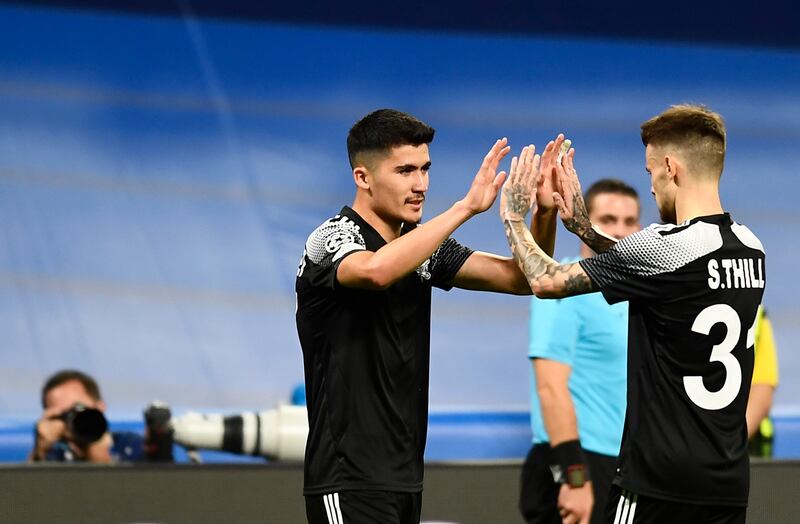 Sheriff's Jasurbek Yakhshiboev, left, celebrates with Sebastien Thill after scoring his side's opening goal during the Champions League win at Real Madrid. AP