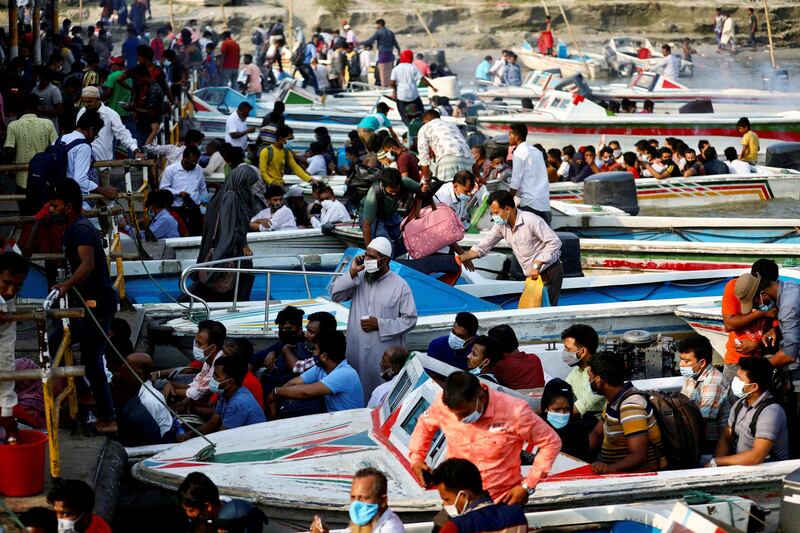 Migrants and workers in Bangladesh leave in speedboats ahead of the countrywide Covid-19 lockdown. Reuters