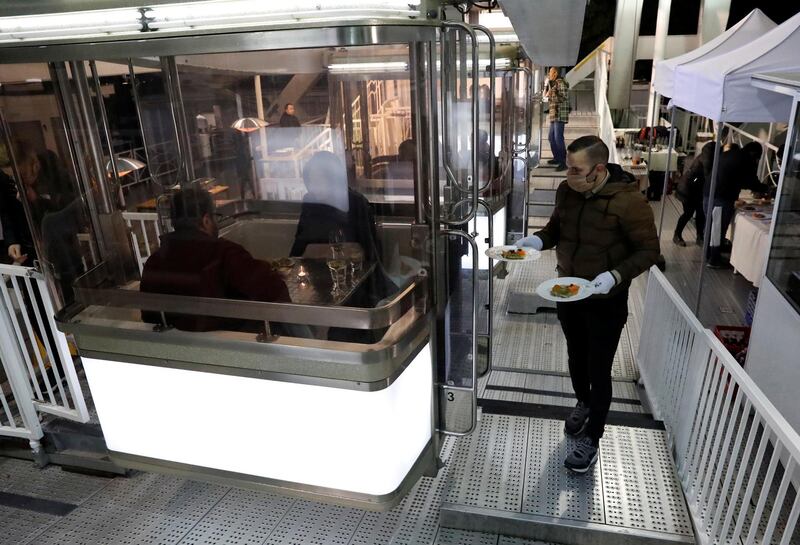 A waiter serves customers on the rotating wheel. Reuters