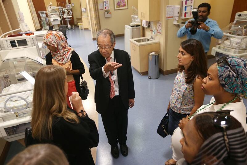 Cheow Seng Lee, hospital chief executive, leads a group of mothers on a tour of the recently opened Danat Al Emarat and explains the facilities. Delores Johnson / The National