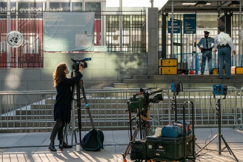 A journalist films United Nations security outside the main entrance to the UN headquarters. AP Photo