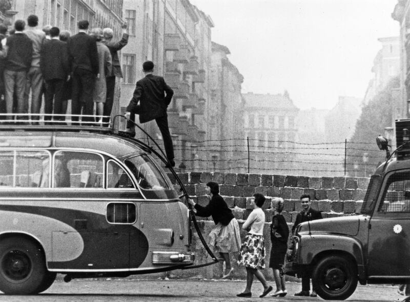 BERLIN - 1964:  (FILE PHOTO)  Saturday, August 13th will celebrate 50 Years Since East German Troops Sealed The Border Between East And West Berlin
Please refer to the following profile on Getty Images Archival for further imagery. 
http://www.gettyimages.co.uk/EditorialImages/News?parentEventId=120436353
and
http://www.gettyimages.co.uk/Search/Search.aspx?EventId=120437101&EditorialProduct=Archival
And Also
In Profile: The Berlin Wall 
http://www.gettyimages.co.uk/Search/Search.aspx?EventId=120436548&EditorialProduct=Archival

Sightseers climb onto a bus to look at the newly-built Berlin Wall in 9164 in Berlin, Germany.   (Photo by Keystone/Getty Images) *** Local Caption ***  2668741.jpg