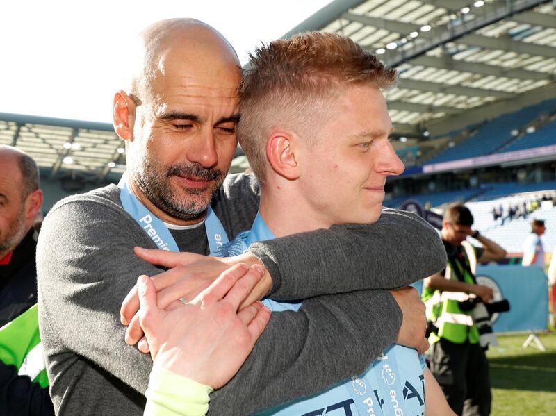 Soccer Football - Premier League - Brighton & Hove Albion v Manchester City - The American Express Community Stadium, Brighton, Britain - May 12, 2019  Manchester City manager Pep Guardiola embraces Oleksandr Zinchenko as they celebrate winning the Premier League           Action Images via Reuters/John Sibley  EDITORIAL USE ONLY. No use with unauthorized audio, video, data, fixture lists, club/league logos or "live" services. Online in-match use limited to 75 images, no video emulation. No use in betting, games or single club/league/player publications.  Please contact your account representative for further details.