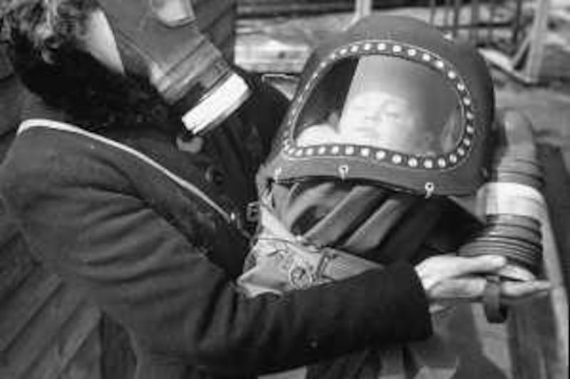 Mother and baby wearing gas masks during gas preparations test during WWII.  (Photo by Hans Wild//Time Life Pictures/Getty Images)