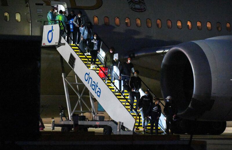 Tennis players and officials arrive on a charter flight in Melbourne. AFP