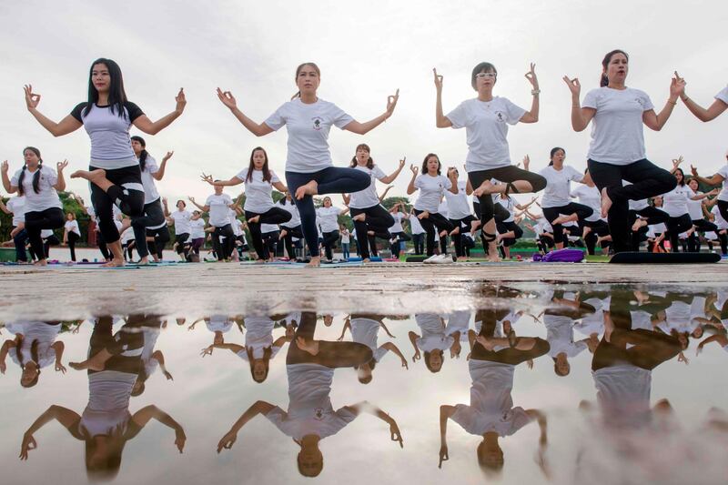 People participate in an outdoor yoga session at a park in Yangon on June 21, 2018 to celebrate the International Yoga Day. Ye Aung THU / AFP