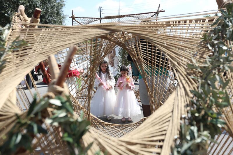 Christians celebrate Palm Sunday during a mass held at Lady of Damascus church in the Christian neighbourhood of Al Qassaa in the Syrian capital, on March 28, 2021. EPA