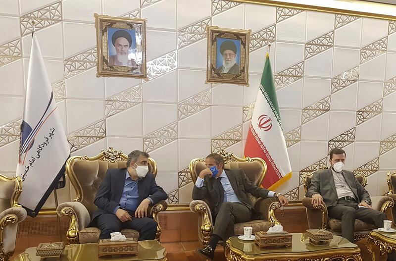 Rafael Grossi, head of the International Atomic Energy Agency, centre, talks to deputy head of the Atomic Energy Organisation of Iran, Behrouz Kamalvandi, left, in Tehran. Mr Grossi will hold talks with Iranian officials as the IAEA considers action against the country. AP