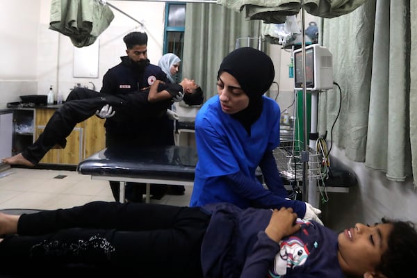 Palestinian medics treat young people wounded in a camp for the displaced in Rafah. AP
