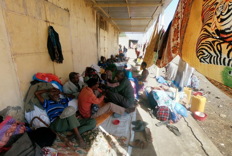 Ethiopians who fled the ongoing fighting in Tigray region sit with their belongings in Hamdait village on the Sudan-Ethiopia border in eastern Kassala state, Sudan. Reuters