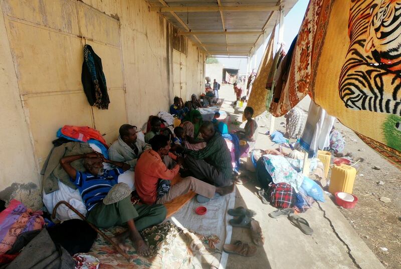 Ethiopians who fled the ongoing fighting in Tigray region sit with their belongings in Hamdait village on the Sudan-Ethiopia border in eastern Kassala state, Sudan. Reuters