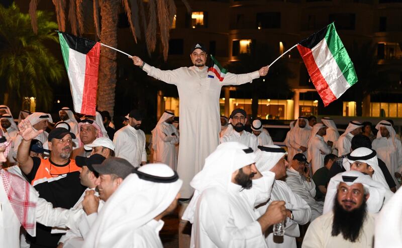 A Kuwaiti man waves the national flag during a demonstration against alleged government corruption, at the Irada Square, opposite the National Assembly in Kuwait City, Kuwait.  EPA