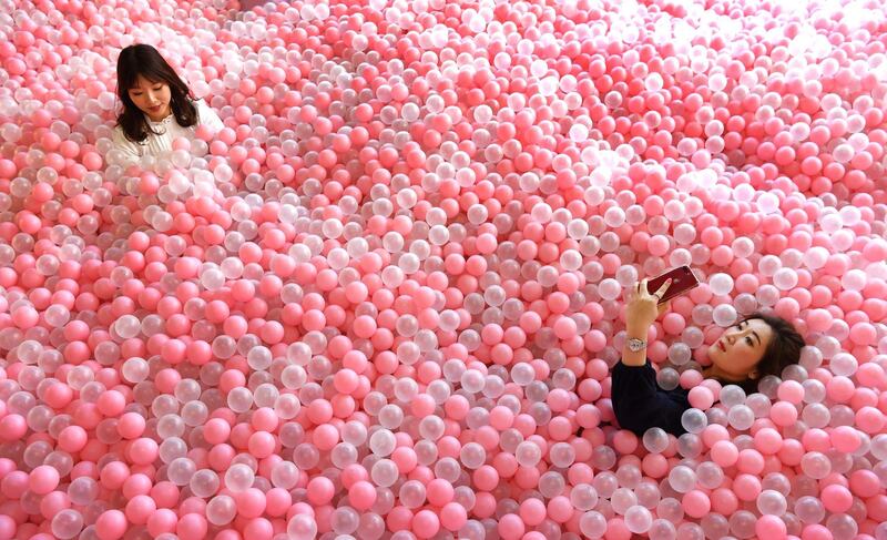 A visitor to Sugar Republic takes a selfie in a ball pit in Melbourne. AFP Photo