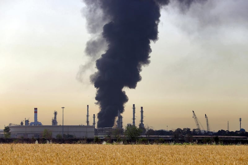 A dark plume of smoke rises up from a main oil refinery south of Tehran, Iran, Thursday, June 3, 2021. A massive fire broke out Wednesday night at the oil refinery serving Iran's capital, sending thick plumes of black smoke over Tehran. (AP Photo/Ebrahim Noroozi)