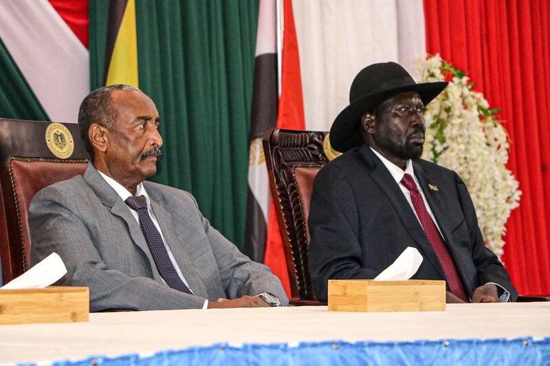 President of Sudanese Transitional Council General Abdel Fattah al-Burhan (L) and President of South Sudan Salva Kiir attend a meeting to endorse the peace talks between Sudan's government and rebel leaders in Juba, South Sudan, on October 14, 2019.   / AFP / Peter LOUIS
