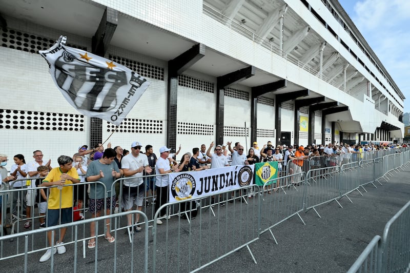 Mourners queue outside the Urbano Caldeira Stadium ahead of Pele's wake ceremony. Getty