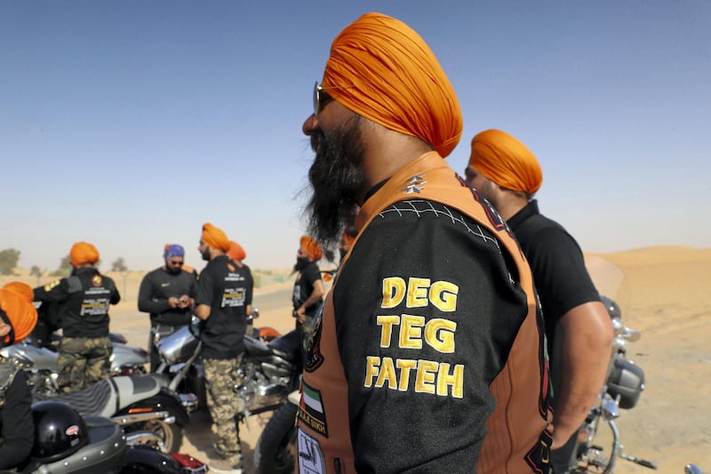 DUBAI ,  UNITED ARAB EMIRATES , May 17 – 2019 :- Members of the SMC ( Singhs Motorcycle Club UAE ) taking a break during the morning bike ride in Dubai. They are into charity events also. This Club was founded by Gurnam Singh and Tanuj Singh in 2014. They ride every Friday morning in different parts of the UAE. Deg Tegh Fateh (Punjabi: ਦੇਗ ਤੇਗ਼ ਫ਼ਤਿਹ, or Victory to Charity and Arms) is a Sikh slogan in the Punjabi language that signifies the dual responsibility of the Khalsa: to provide food and protection for the needy and oppressed. ( Pawan Singh / The National ) For Arts&Culture/Big Picture/Instagram/Online. Story by Kate