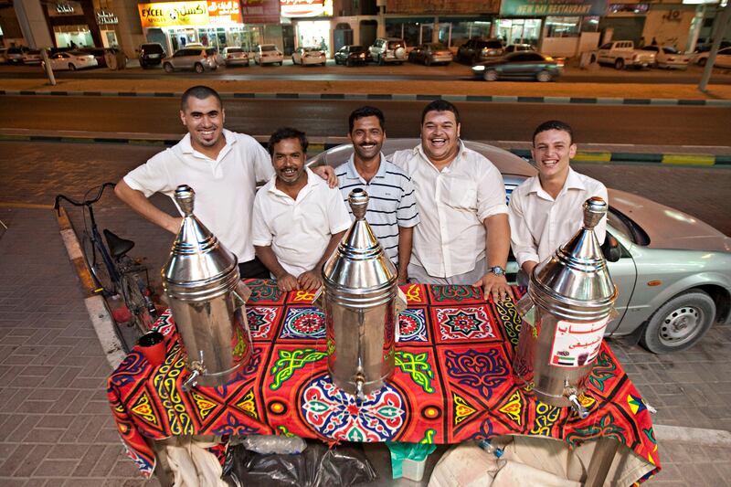 Ajman, August 7, 2011 - From left Haysme Abdo, Mohammed Abdul Safur, Tahir Mahmood, Manager Mohamed Magdi and Mohamed Abdel Hamed outside the Al Koroum Cafeteria where they work in Ajman City, August 7, 2011. (Jeff Topping/The National) 