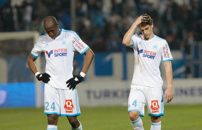 Marseille's Rod Fanni, left and Lucas Mendes react after losing to Nice on Friday night. Claude Paris / AP / March 7, 2014