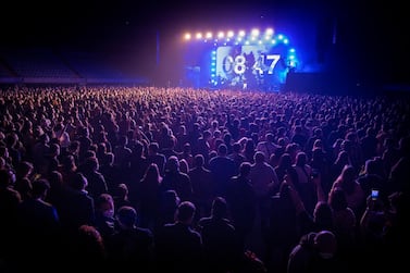 People attend a music concert in Barcelona, Spain, Saturday, March 27, 2021. Five thousand music lovers are set to attend a rock concert in Barcelona on Saturday after passing a same-day COVID-19 screening to test its effectiveness in preventing outbreaks of the virus at large cultural events. The show by Spanish rock group Love of Lesbian has the special permission of Spanish health authorities. While the rest of the country is limited to gatherings of no more than four people in closed spaces, the concertgoers will be able to mix freely while wearing face masks. (AP Photo/Emilio Morenatti)