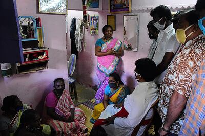 A church priest (C bottom) consoles family members of Jayaraj, 58, and son Bennicks Immanuel, 31, allegedly tortured at the hands of police in Sathankulam, Thoothukudi district in the Indian state of Tamil Nadu on June 28, 2020. The deaths of a father and son from alleged torture at the hands of police have sparked outrage across India, with many drawing parallels with the killing of George Floyd in the United States. / AFP / STR
