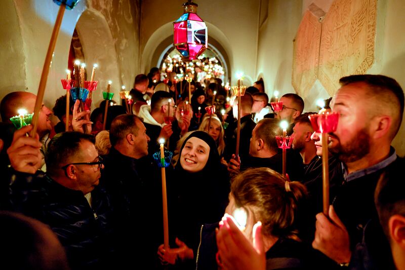 Christian Orthodox nuns hold candles and sing during the Orthodox Christian Easter service at St John the Baptist near Mavrovo, Republic of North Macedonia. EPA