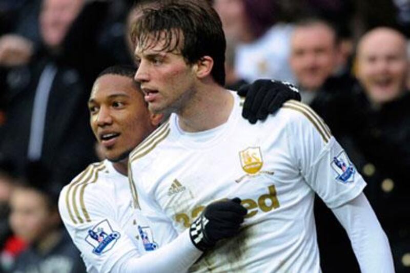 Despite interest from bigger clubs such as Barcelona, Real Madrid and Chelsea, Swansea's 26-year-old Michu, right, says he is happy right where he is.