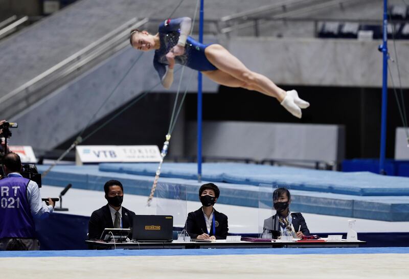 Judges watch Russia\s Alexandra Shchekoldina perform in a floor exercise event. AP
