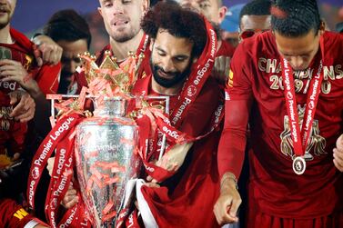 Liverpool's Mohamed Salah with the Premier League trophy after the 2019-20 season. PA