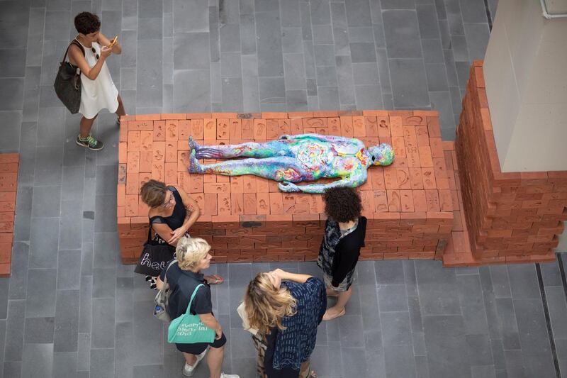 Visitors look at the artwork 'Body Bricks' by artist Mariechen Danz during the 16th Istanbul Biennial at the Mimar Sinan Fine Arts University in Istanbul, Turkey.  EPA