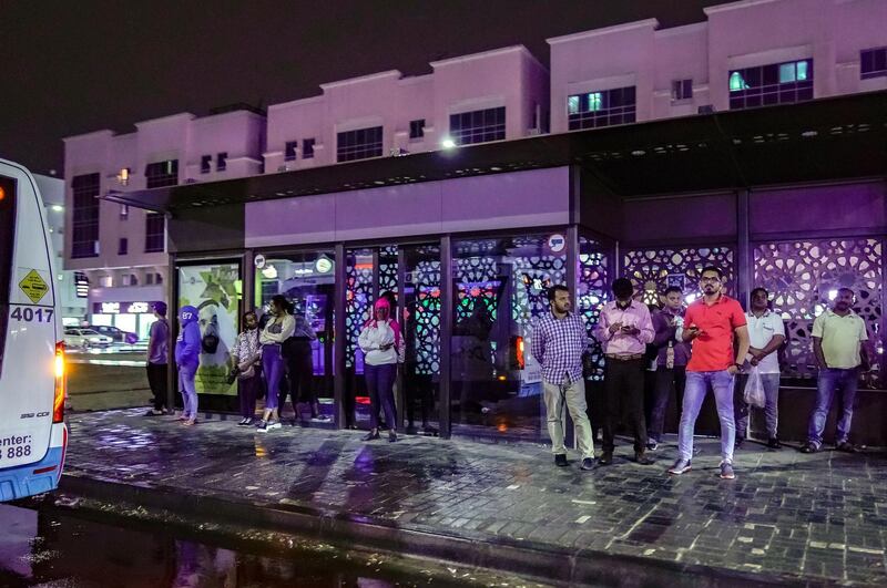 Abu Dhabi, United Arab Emirates, January 9, 2020.  Commuters wait for their bus as it pours at Khalifa City.    
Victor Besa / The National