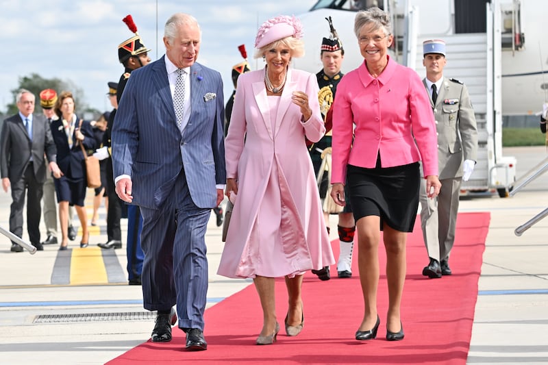 French Prime Minister, Ms Elisabeth Borne, right, welcomes King Charles and Queen Camilla at Orly Airport. PA