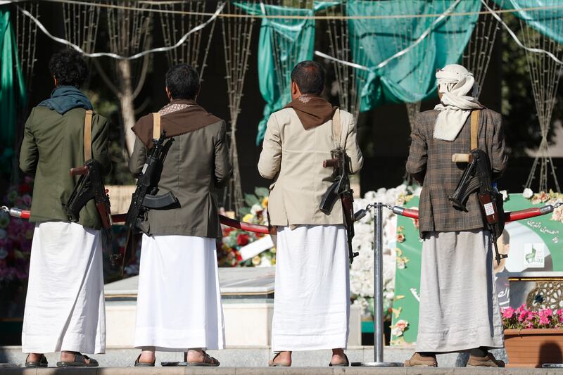 Armed Houthi fighters visit a shrine for slain comrades in Sanaa on Wednesday. The US returned the rebels to its list of foreign terrorist organisations this week. EPA