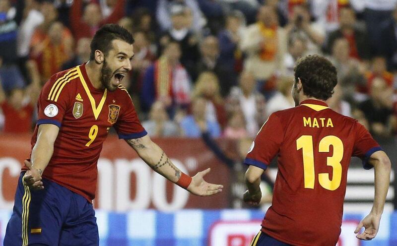 Spain 2-0 Georgia. Spain, like England, had not yet officially qualified, but took care of that thanks to goals from Alvaro Negredo, left, and Juan Mata, right. Juan Medina / Reuters