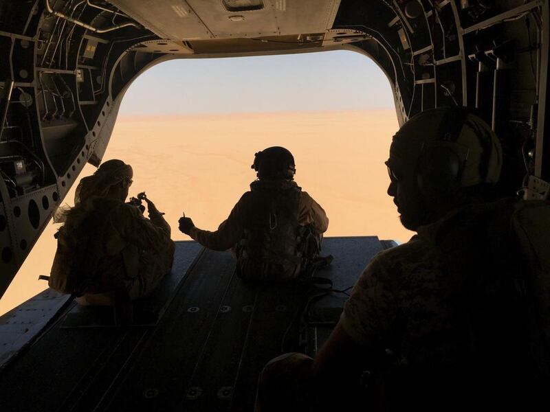 An airman from the UAE Armed Forces gives a comrade a bullet during a flight from a base in Saudi Arabia to the front line of the anti-Houthi offensive in Yemen’s Marib province. UAE and Saudi forces have played a leading role in the months-long campaign to liberate Yemen from the Iran-allied rebels. Noah Browning / Reuters