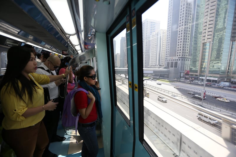 DUBAI , UNITED ARAB EMIRATES Ð Sep 3 , 2014 : People traveling in Dubai Metro in Dubai. ( Pawan Singh / The National ) For News. Story by Preeti & Martin
