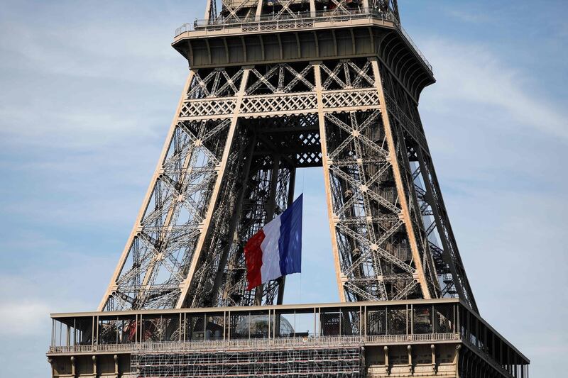 A French national flag is displayed on the Eiffel Tower in Paris, as part of celebrations marking the 75th anniversary of World War II victory in Europe. AFP